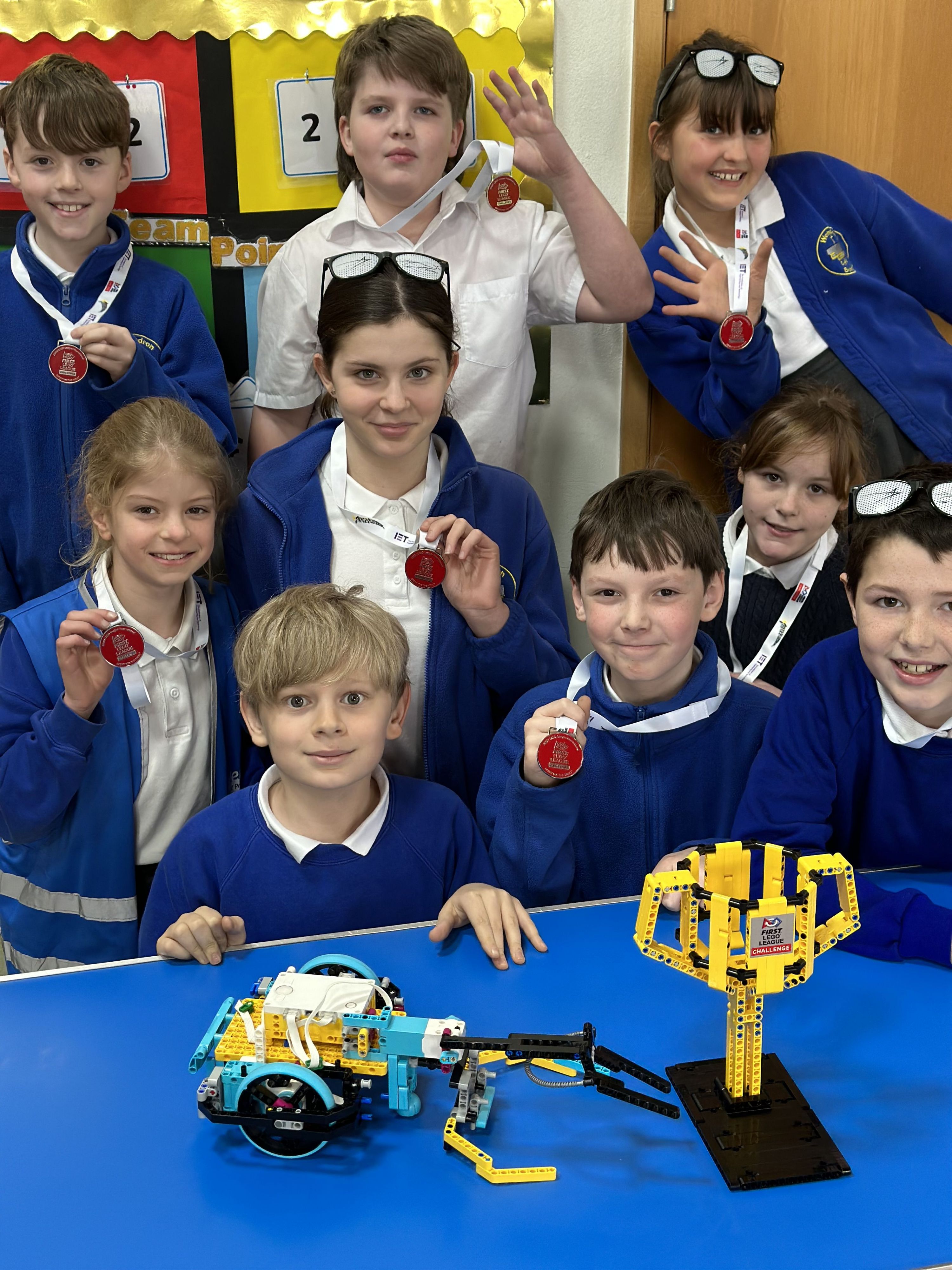 children showing off their science badges