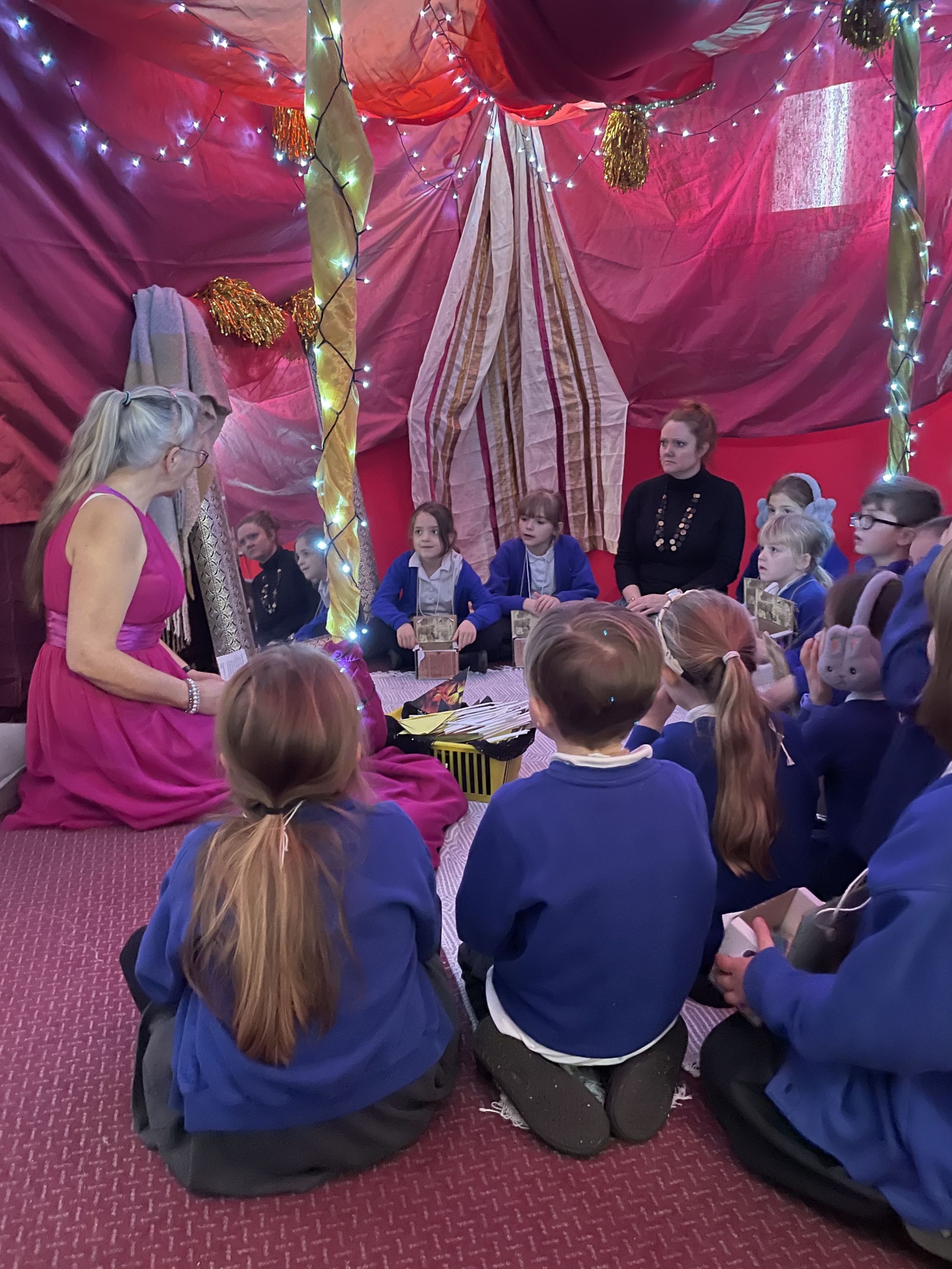 children in a fairy tent having a story