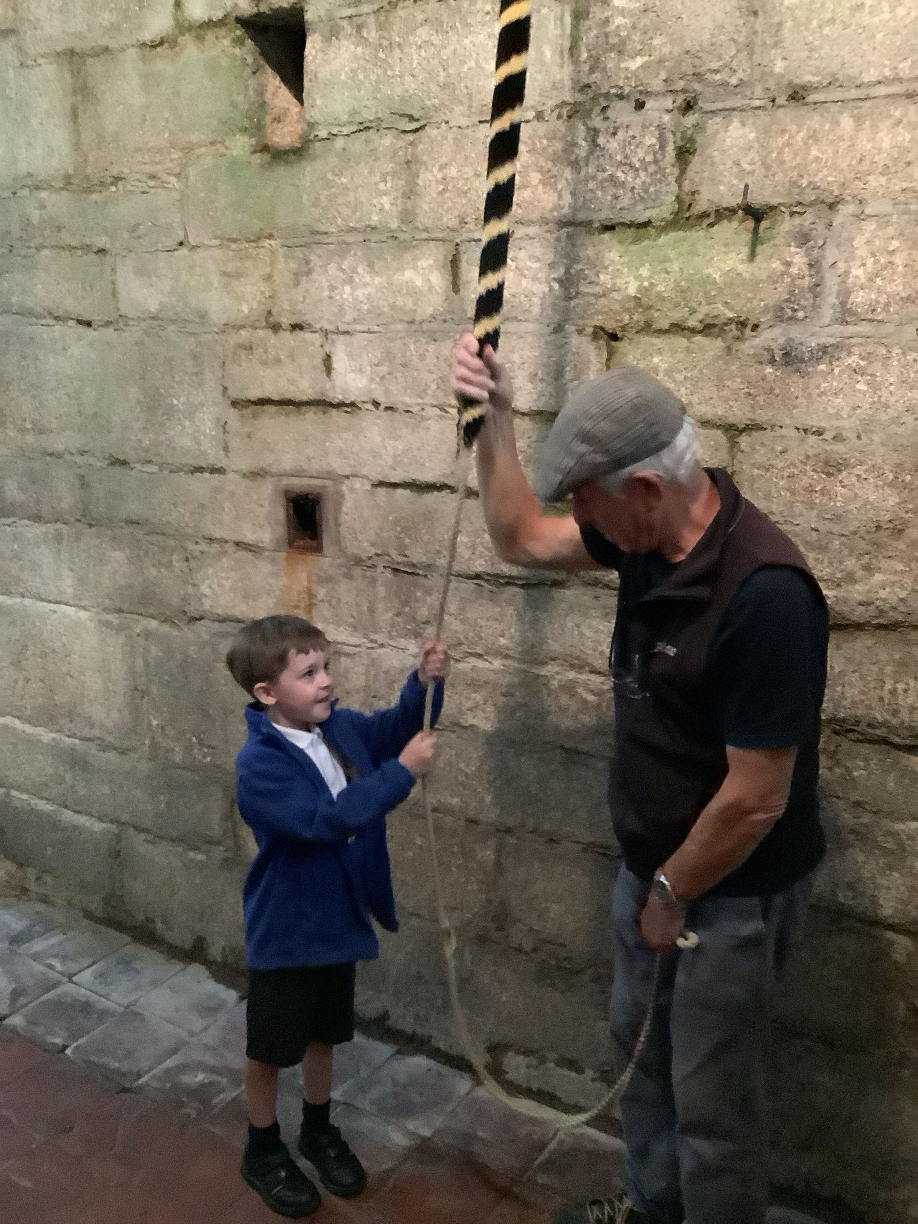 child pulling the church bell