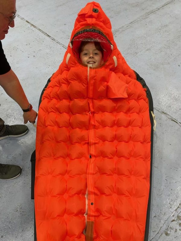 Child in a survival floating boat