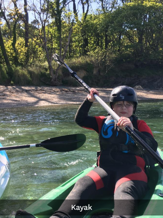 child paddaling a kayak