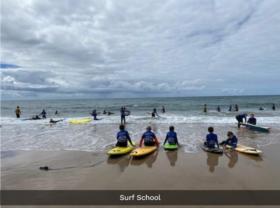 children taking part in surf school